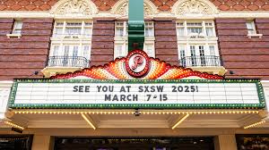 Marquee of a theater displaying the message: "SEE YOU AT SXSW 2025! MARCH 7-15." The building features decorative elements and red brickwork.